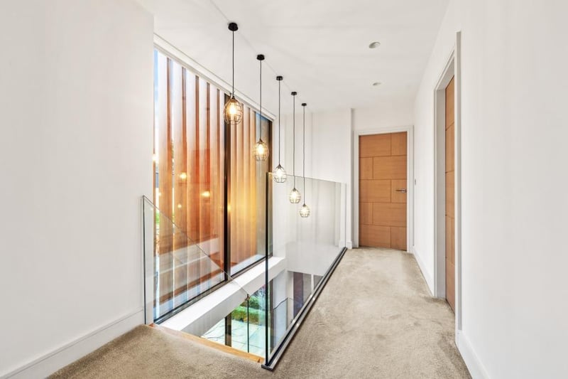 The gallery landing from the open oak staircase with glass balustrade.