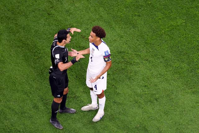 DOHA, QATAR - NOVEMBER 21: Tyler Adams #4 of United States discusses a yellow card given to teammate Sergiño Dest in the first half against Wales during the FIFA World Cup Qatar 2022 Group B match between USA and Wales at Ahmad Bin Ali Stadium on November 21, 2022 in Doha, Qatar. (Photo by Elsa/Getty Images)