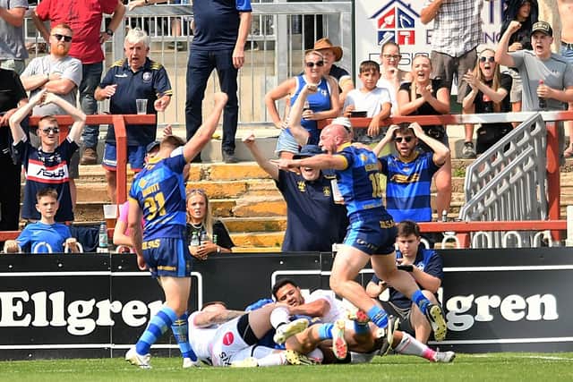 Trinity players celebrate after Jack Croft scores the opening try in the shock win over Leeds. Picture by Simon Hulme.