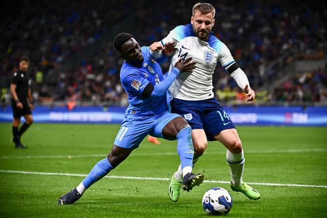 Italy's forward Wilfried Gnonto (L) and England's defender Luke Shaw fight for the ball during the UEFA Nations League's League A Group 3 match between Italy and England, at the San Siro Stadium in Milan on September 23, 2022. (Photo by Marco BERTORELLO / AFP) (Photo by MARCO BERTORELLO/AFP via Getty Images)