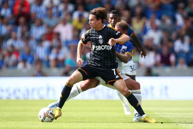 BRIGHTON, ENGLAND - AUGUST 27: Brenden Russell Aaronson of Leeds holds off Brighton's Alexis Mac Allister during the Premier League match between Brighton & Hove Albion and Leeds United at American Express Community Stadium on August 27, 2022 in Brighton, England. (Photo by Charlie Crowhurst/Getty Images)