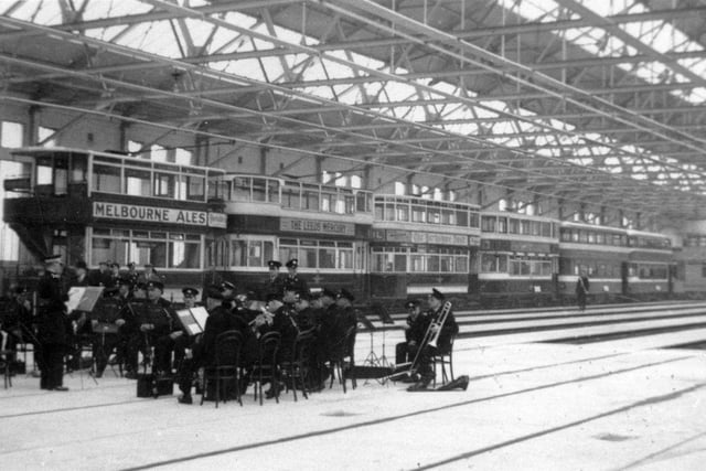 The opening of the new tram depot on Torre Road in April 1937. The opening was performed by Sir Josiah Stamp who was chairman of the LMS Railway Company. It is believed he drove tram No 247A, which is at the head of the line of trams, representing all the types then in service in Leeds. Car 247A was built in 1901 and would have been about the oldest in the fleet. Originally built as an open-topper, it had a top-cover fitted in 1910 and windscreens at a later date. The windscreens have been removed for this occasion, presumably to create an "old and new" contrast with the other trams in the procession. 247A's claim to fame was brief as it was taken out of service a couple of weeks later. The band performing in the foreground is the Leeds City Tramways Brass Band.