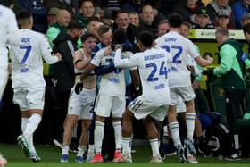 DOUBLE DELIGHT: Crysencio Summerville, centre, is smothered as he celebrates scoring his second and Leeds United's third to seal a stunning comeback 3-2 victory at Saturday's Championship hosts Norwich City. Photo by George Tewkesbury/PA Wire.