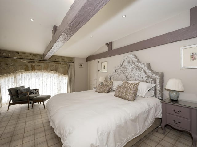 This double bedroom has a stone arch window feature.