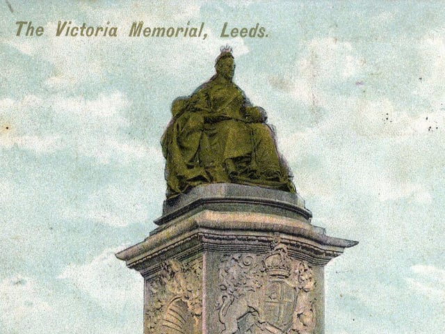 A colour tinted postcard dated August 1906 showing the Queen Victoria memorial statue sculpted by George Frampton which was unveiled the previous year. The queen herself is depicted sitting at the top of a pedestal in Coronation robes and crown.
