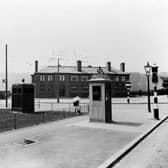 The junction of Meanwood Road and Stainbeck Road in June 1936. On the left, Buslingthorpe Rugby league ground is behind fence with Woodhouse Ridge in the background. Then the Meanwood Hotel, public house, landlord William Cardis. The road to the right of the Meanwood is Grove Lane, Stainbeck Road is in the bottom right corner. Street furniture includes a police box on the left, public telephone box, traffic lights and gas lamp.
