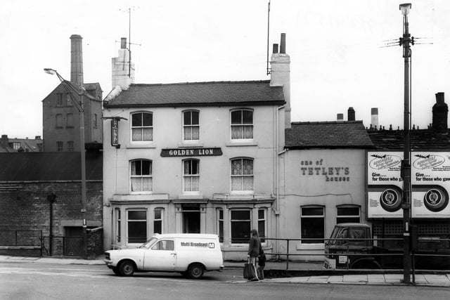 The Golden Lion Public House on Armley in October 1977. In front of this large, bay windowed Tetley house is a van with the sign Multi-Broadcast Colour TV Rentals on the side. On the far right can be seen a lorry bearing the name Holt Brothers (Halifax) Ltd., Heat Treatment Contractors. Above this sign an advertisement reads, 'Remember Wings Appeal during September. Give for those who gave. The work of the Royal Air Force Association is never ending, will you help'.