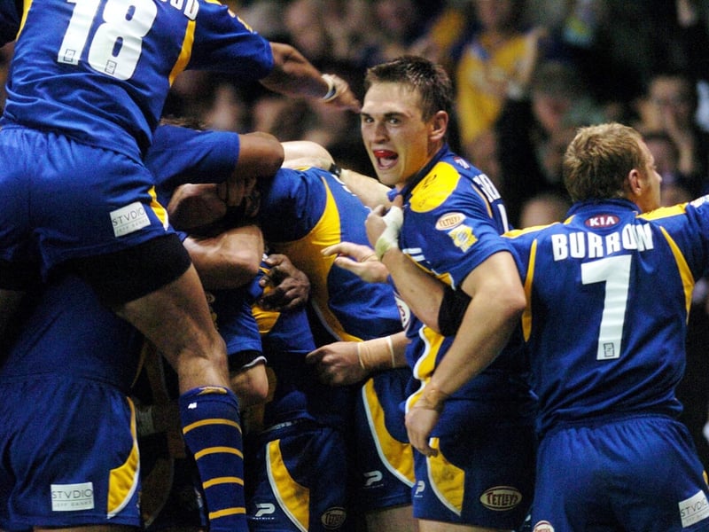 Danny McGuire is mobbed by jubilant teammates after his late try.