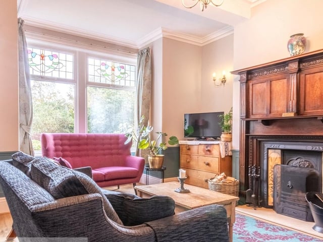 A stunning feature fireplace is a focal point of this room, with a large bay window.