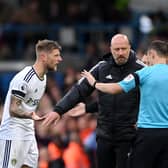 LEEDS, ENGLAND - OCTOBER 02: Liam Cooper of Leeds United protests to Match Referee Stuart Attwell as team mate Luis Sinisterra (not pictured) is shown a red card during the Premier League match between Leeds United and Aston Villa at Elland Road on October 02, 2022 in Leeds, England. (Photo by Stu Forster/Getty Images)