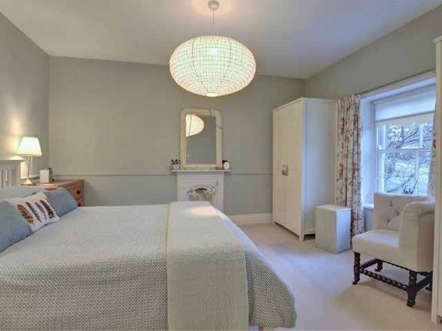 A double bedroom with charming fireplace.