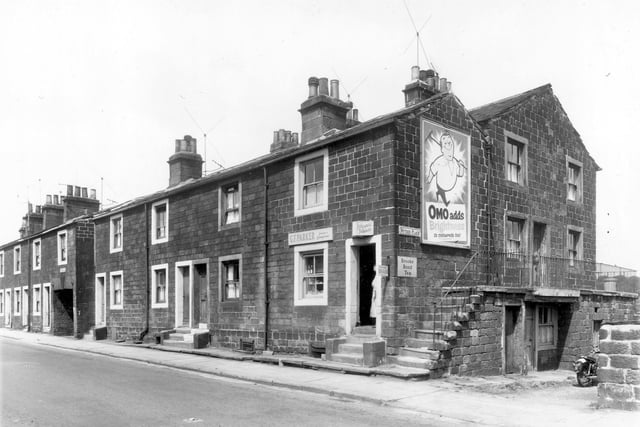 A row of four back-to-back terraced properties with access on the far left to the houses at the rear on Wyther Place. On the right is G.F. Parker greengrocers. Pictured in June 1959.