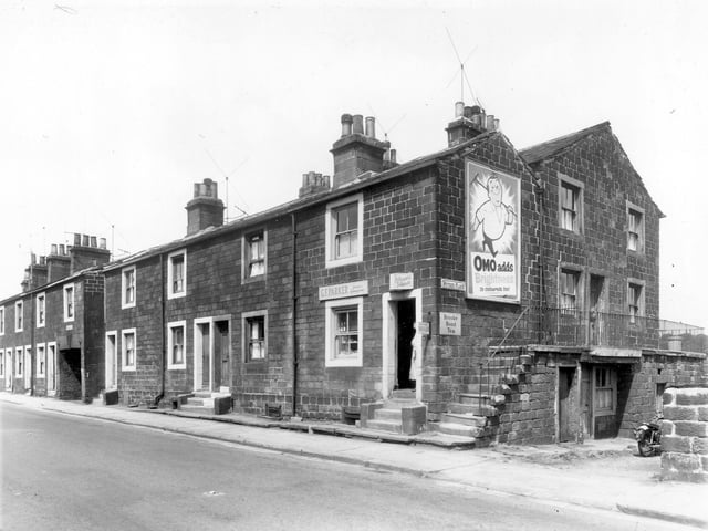 A row of four back-to-back terraced properties with access on the far left to the houses at the rear on Wyther Place. On the right is G.F. Parker greengrocers. Pictured in June 1959.