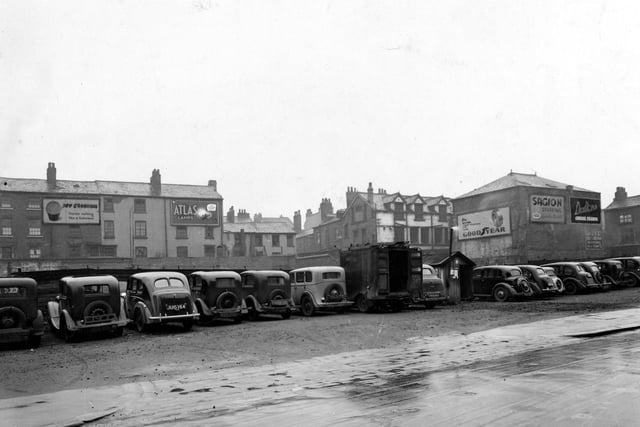 The car park on Merrion Street. Billboards in the background for Guinness, Atlas Lamps, Goodyear Tyres, Sagion Stuffing and Dalton's Cereal Flakes.