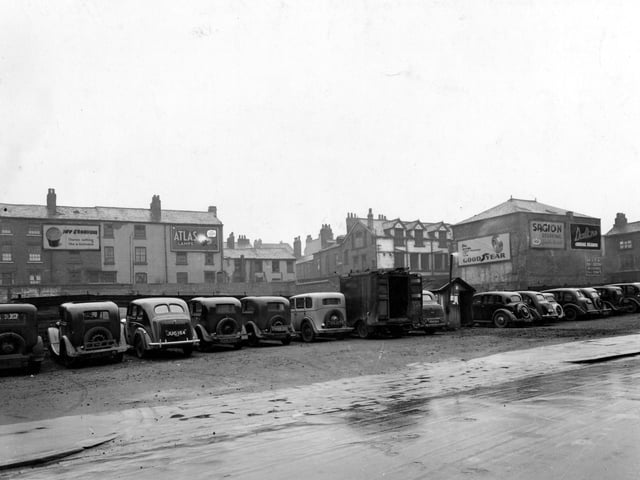 The car park on Merrion Street. Billboards in the background for Guinness, Atlas Lamps, Goodyear Tyres, Sagion Stuffing and Dalton's Cereal Flakes.