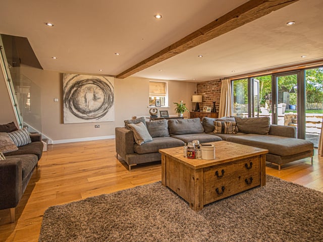 Wood, exposed brick and glass combined add warmth to the modern interior.