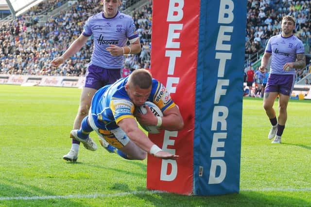 Leeds Rhinos forward Tom Holroyd soars over for a try in the 36-12 win against Warrington Wolves at AMT Headingley. Picture by Steve Riding.