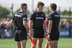 Matty Lynn, with red flag, will referee Leeds Rhinos' Challenge Cup tie against Wests Warriors on Saturday. He is seen with fellow officials Adam Williams and Matthew Rossleigh during a game between Oldham and Dewsbury Rams in 2023. Picture by Olly Hassell/SWpix.com.