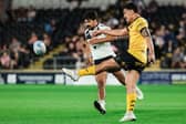 Daejarn Asi gets a kick away during Castleford Tigers' win at Hull last week, which will send them into Saturday's game at St Helens in good heart according to rugby director Chris Chester. Picture by Alex Whitehead/SWpix.com.