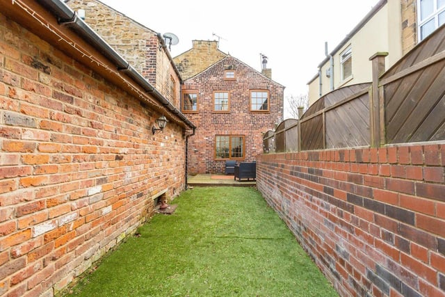 Externally, a large covered carport leads to a spacious workshop to the side of the property. Off-street parking is provided to the front of the property via decorative stone paving with cottage-style gardens.