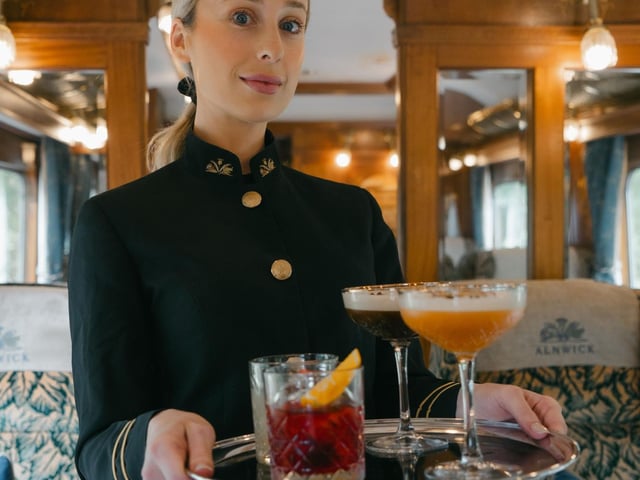 Cocktails ... a steward serves drinks aboard the Northern Belle