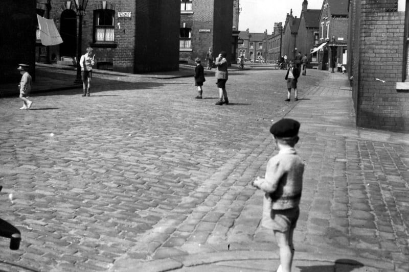 Children play on Normanton Street in June 1951. The view looks west towards the junctions with St. Luke's Terrace and St. Luke's Place.