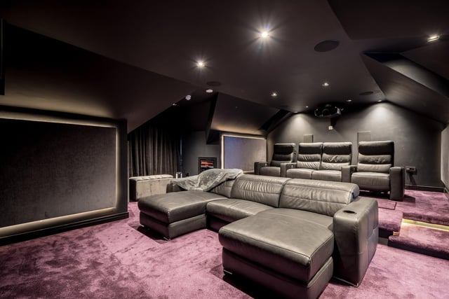 The plush cinema room with Dolby Atmos surround sound system has a projector and projector screen with the ability to play or stream TV and Movies as well as music.