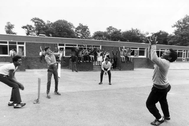 Pupils play their last over in July 1984 before the closure of Elmhurst Middle School. Pictured, from left, are David Willett, Parvez Shan, Amritpal Rehal and Eugene Ruan with classmates in the background.
