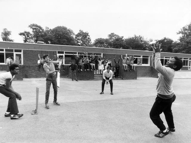 Pupils play their last over in July 1984 before the closure of Elmhurst Middle School. Pictured, from left, are David Willett, Parvez Shan, Amritpal Rehal and Eugene Ruan with classmates in the background.