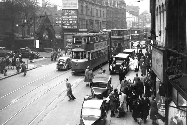 Trams make their way down New Briggate in December 1951.