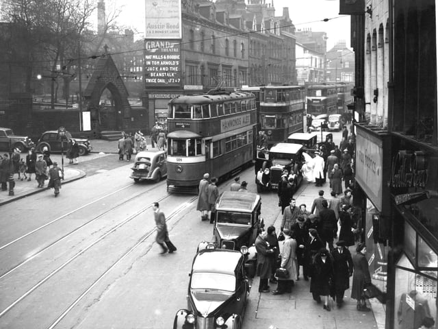 Trams make their way down New Briggate in December 1951.