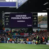 LEEDS, ENGLAND - OCTOBER 16: The LED board shows the VAR screen checking for a possible penalty during the Premier League match between Leeds United and Arsenal FC at Elland Road on October 16, 2022 in Leeds, England. (Photo by Eddie Keogh/Getty Images)