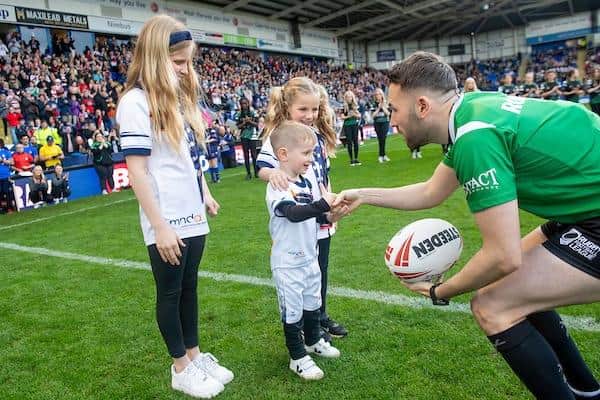 Rob Burrow's children, Macy, Jackson and Maya hand the match ball to referee Liam Moore before England's win over France. Picture by Allan McKenzie/SWpix.com.