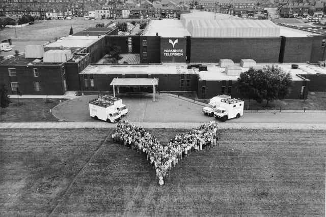 Staff at Yorkshire Television line up outside their base on Kirkstall Road to form shape of the YTV emblem. Pictured in August 1986.