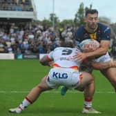 Leeds Rhinos' man of the match Jake Connor is tackled by former teammate Andy Ackers during the 42-12 win against Bradford Bulls. Picture by Steve Riding.
