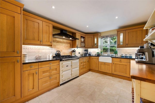 The kitchen is fitted with an extensive range of storage with integrated appliances and an Aga range cooker.