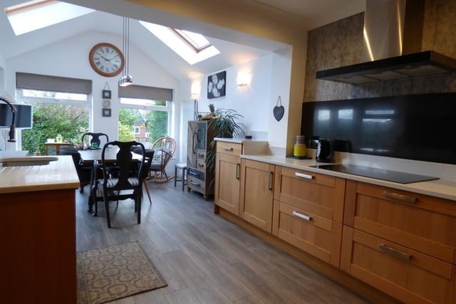 The dining area adjoining the kitchen has large feature windows.