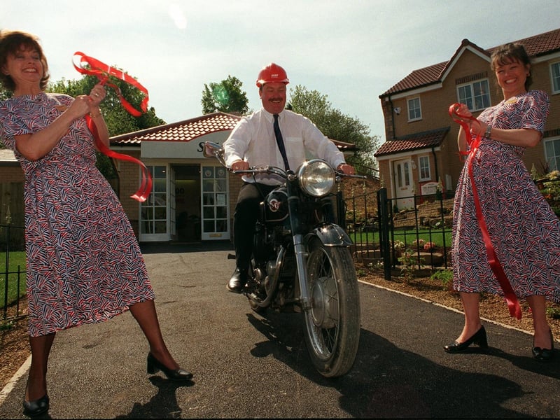 Site Manager Andrew Bean rides his 1955 Matchless 350cc motorbike through the ribbon held by Margaret Maltby, left, and Anita Mitchell to officially open the new Taywood Homes site at Pudsey's Spring Park in May 1998.