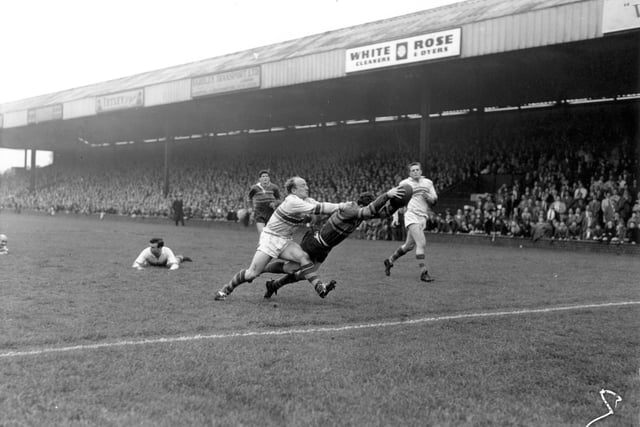 Match action from the clash between Leeds RL and Warrington at Headingley in October 1961. The photograph shows Leeds winger Ratcliffe scoring with Edwards of Warrington unable to stop him. The game finished  10-9 to Leeds.