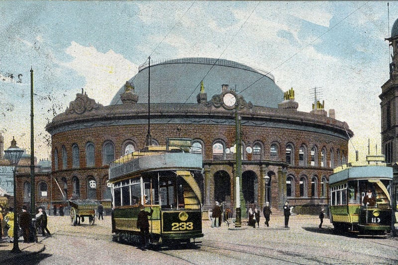 A colour-tinted postcard of the Corn Exchange with a postmark 25th November 1904. The Corn Exchange was designed by Cuthbert Brodrick and opened on 28th July 1863. Two open-top trams are seen outside, no. 233 and no. 113.
