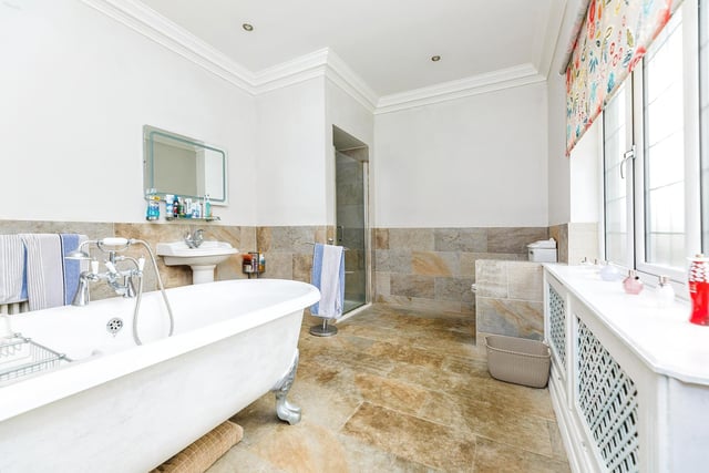 With a free standing bath and tiled floor, this bathroom offers a pleasant space to soak away the stress.