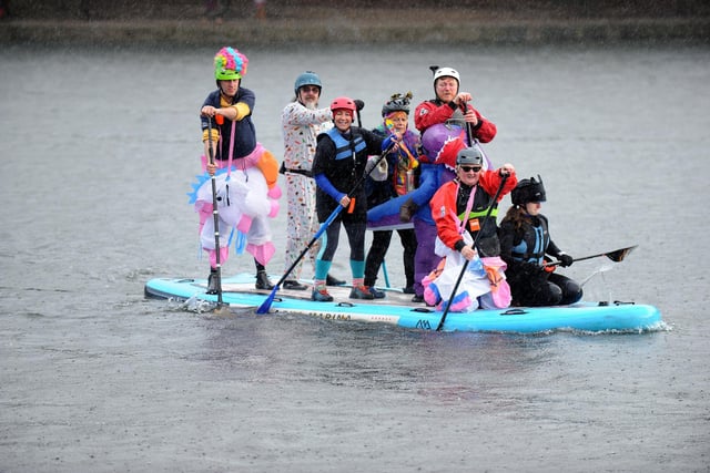 A group wearing fancy dress on the water on New Year's Day.