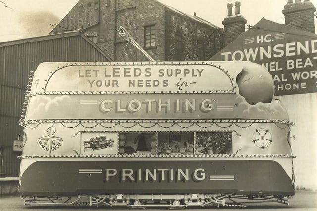 Tram no. 359 decorated for Festival of Britain and pictured in Kirkstall Road with the words "Let Leeds supply your needs in Clothing and Printing" emblazoned on the side and a rotating globe seen at the front. Harold C Townsend, panel beater, is on the right and part of the Kirkstall tram works on the left.