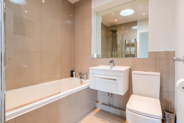 There is a family bathroom with a three-piece white suite, over bath shower and a light tunnel for natural light.