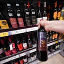 A shopper looking at wine in a Tesco supermarket. Britons will soon be able to buy "pint" sized bottles of still and sparkling wine in the form of a new 568ml amount to appear on supermarket shelves and in pubs, clubs and restaurants, the Government has announced.