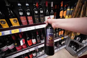 A shopper looking at wine in a Tesco supermarket. Britons will soon be able to buy "pint" sized bottles of still and sparkling wine in the form of a new 568ml amount to appear on supermarket shelves and in pubs, clubs and restaurants, the Government has announced.