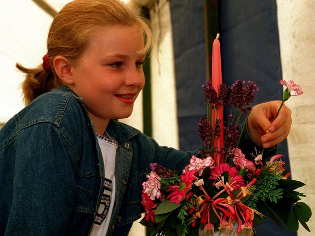 Shadwell Show was celebrating its Golden Jubilee in August 1996. Pictured is Alice Gostling making final adjustments to her By Candle-light flower arrangement.