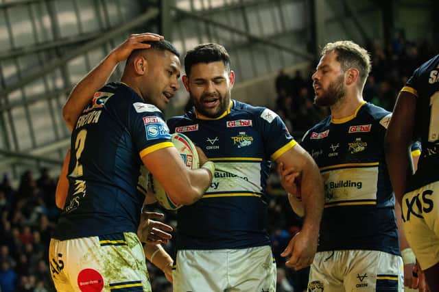 David Fusitu'a, left, celebrates with Rhyse Martin, centre and Aidan Sezer after scoring against Hull. Picture by Bruce Rollinson.