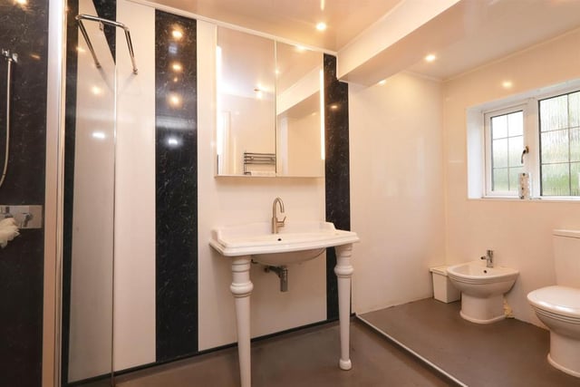 This en-suite has a white four piece suite including a shower cubicle, bidet, wash hand basin and low level wc, window to the rear, spot lights and heated towel rail.