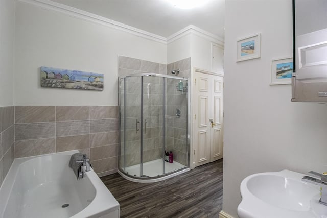A very stylish bathroom with fitted bath tub and separate shower enclosure.
